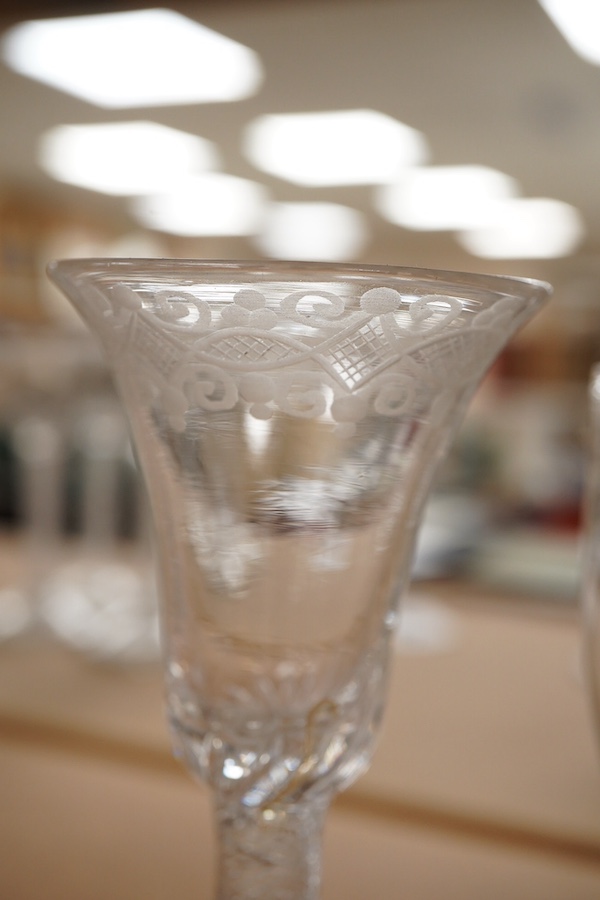 Four Georgian wine glasses, three with engraved bowls, three with faceted stems, and one with an air twist knopped stem and stepped foot, tallest 16cm